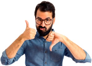 Young hipster man making a good-bad sign